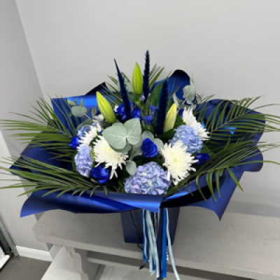 Blue and white bouquet  - Blue roses, blue hydrangeas, white lilies, white blooms, eucalyptus and palms gift wrapped in a bag of water 