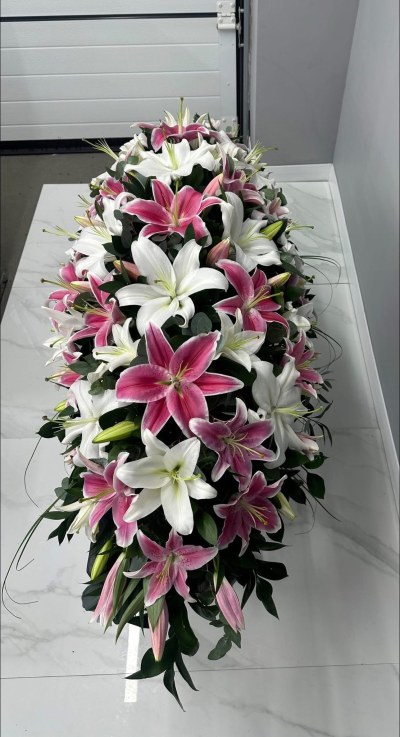Eternal Grace Spray - A breathtaking full-length casket spray designed in an elegant palette of pure white, soft blush pink, and rich green foliage. With its flowing silhouette, luxurious textures, and timeless beauty, this heartfelt tribute symbolises everlasting love, peace, and treasured memories. Thoughtfully handcrafted to honour the life of a cherished loved one, it offers a graceful expression of sympathy, comfort, and respect, creating a dignified and meaningful centrepiece for funeral and memorial services.